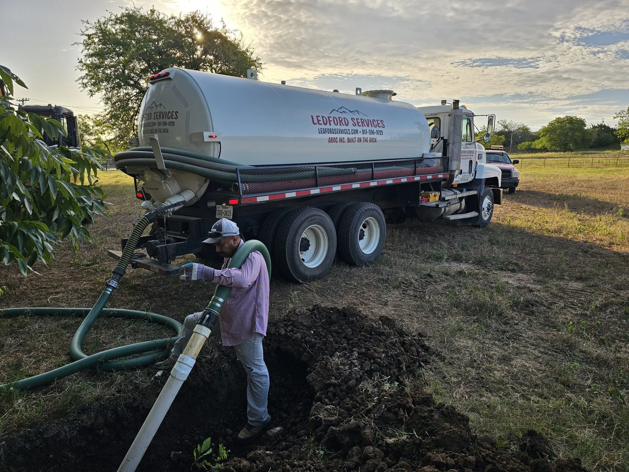 A Ledford Services technician pumping a septic tank from the vacuum truck