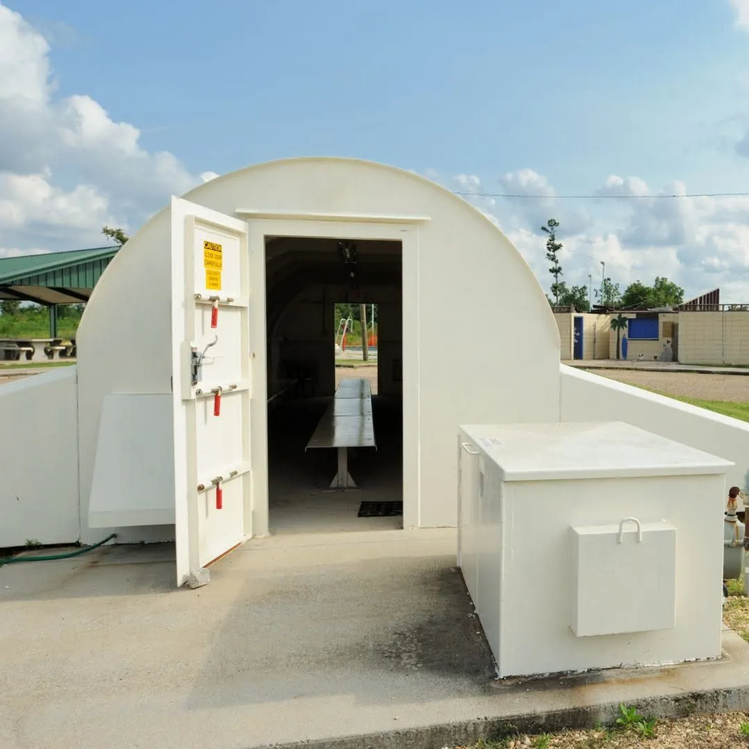 An installed Ledford storm shelter with its door open
